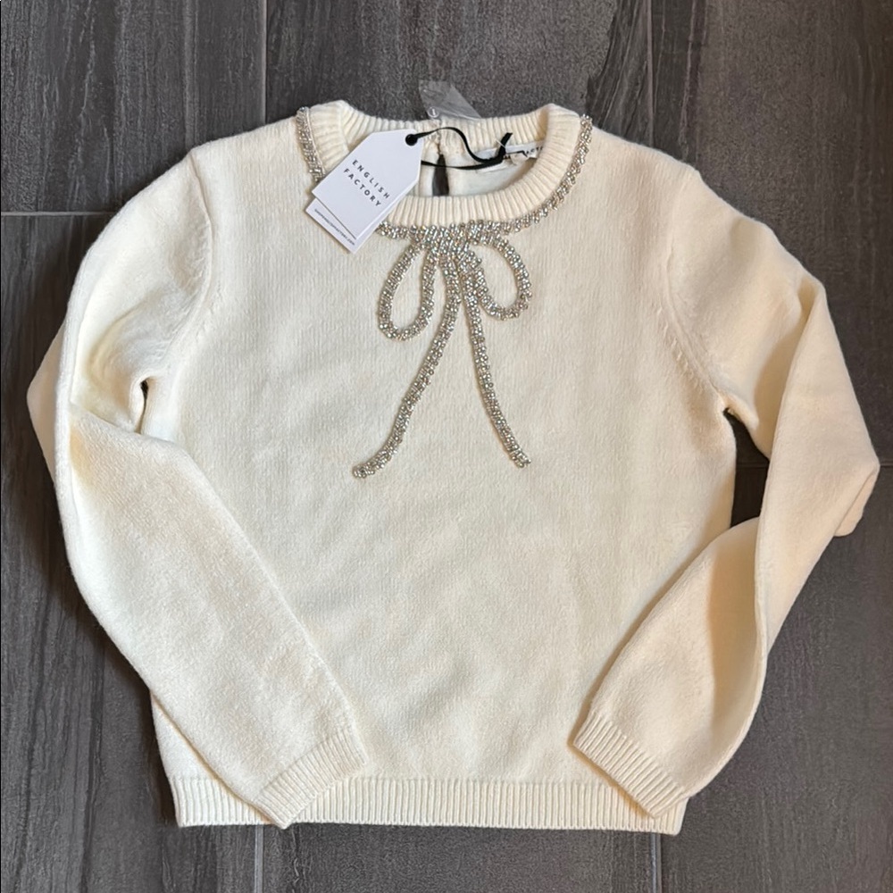 Elegant Cream Sweater with Embellished Bow